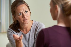 a women talking to her doctor about addiction treatment therapies 