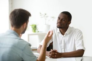 a man talking to his doctor about intensive outpatient treatment 