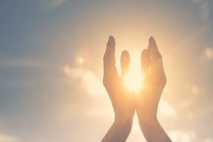 hands reaching up to the sun during aftercare