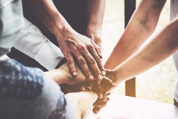 hands in a circle as part of a support group