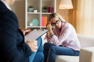 woman talking with therapist in trauma therapy