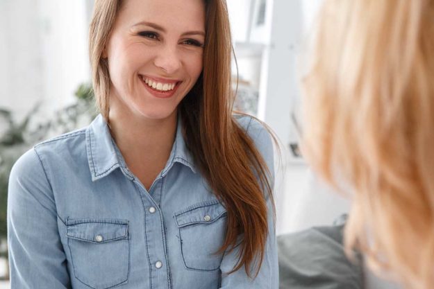 woman smiling in talk therapy