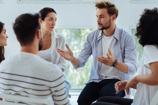 a group participates in group therapy for addiction