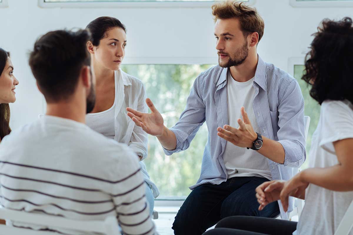 a group participates in group therapy for addiction