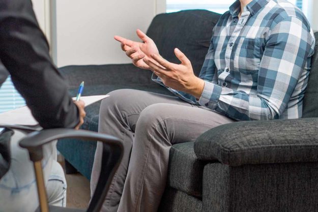 a person talks through his addiction treatment therapies
