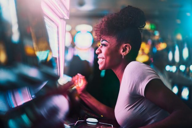 person at slot machine with gambling problem