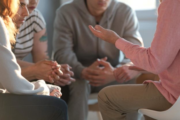 people engaged in group therapy for addiction recovery